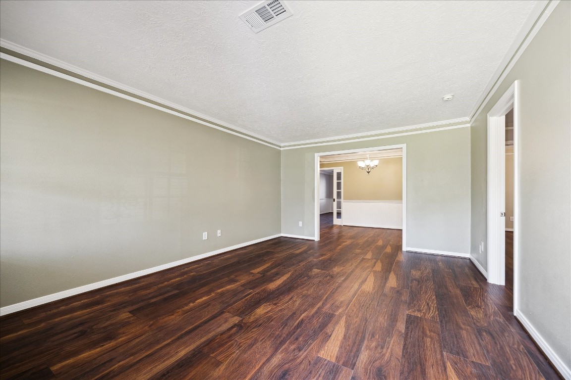 1115 Post Street Houston, TX 77022 - Photo 6 of 23 View from entry room to kitchen area and gathering room. Freshly painted. Crown molding. Wood floors throughout. No carpets!