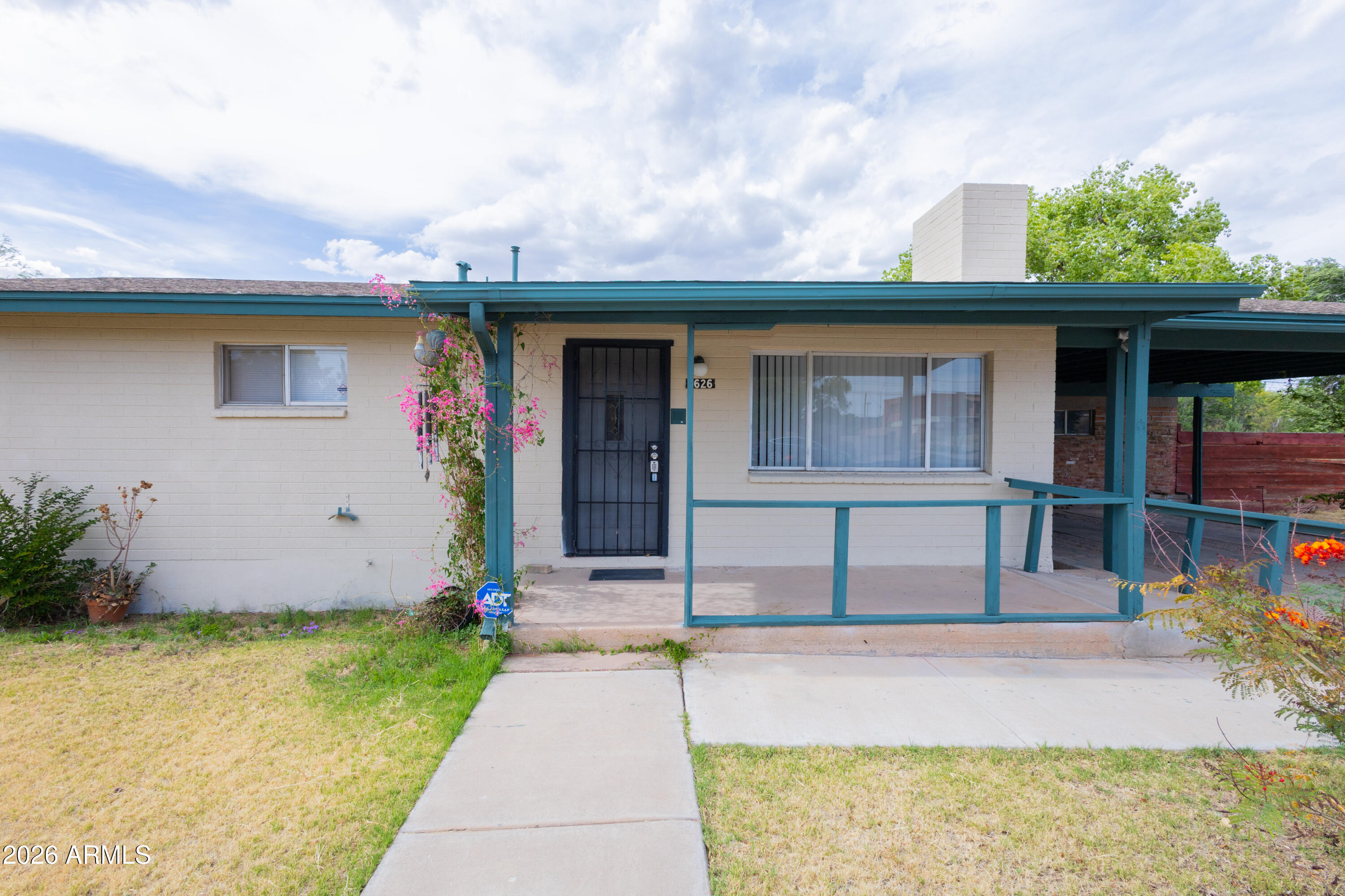 1626 11th Street Douglas, AZ 85607 - Photo 4 of 30 a front view of a house with garden