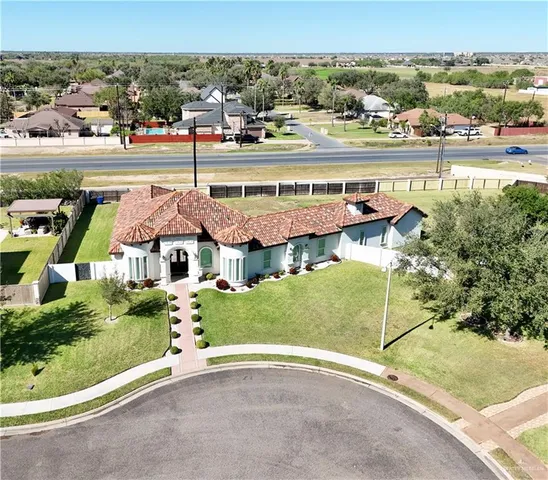 an aerial view of a house with a yard and lake view