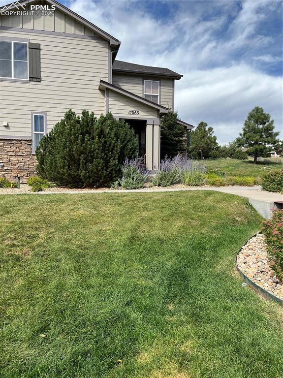 17063 Blue Mist Grove Monument, CO 80132 - Photo 30 of 33 a front view of a house with a garden