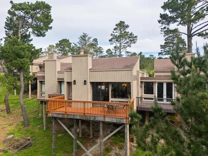 a view of a house with backyard porch and sitting area