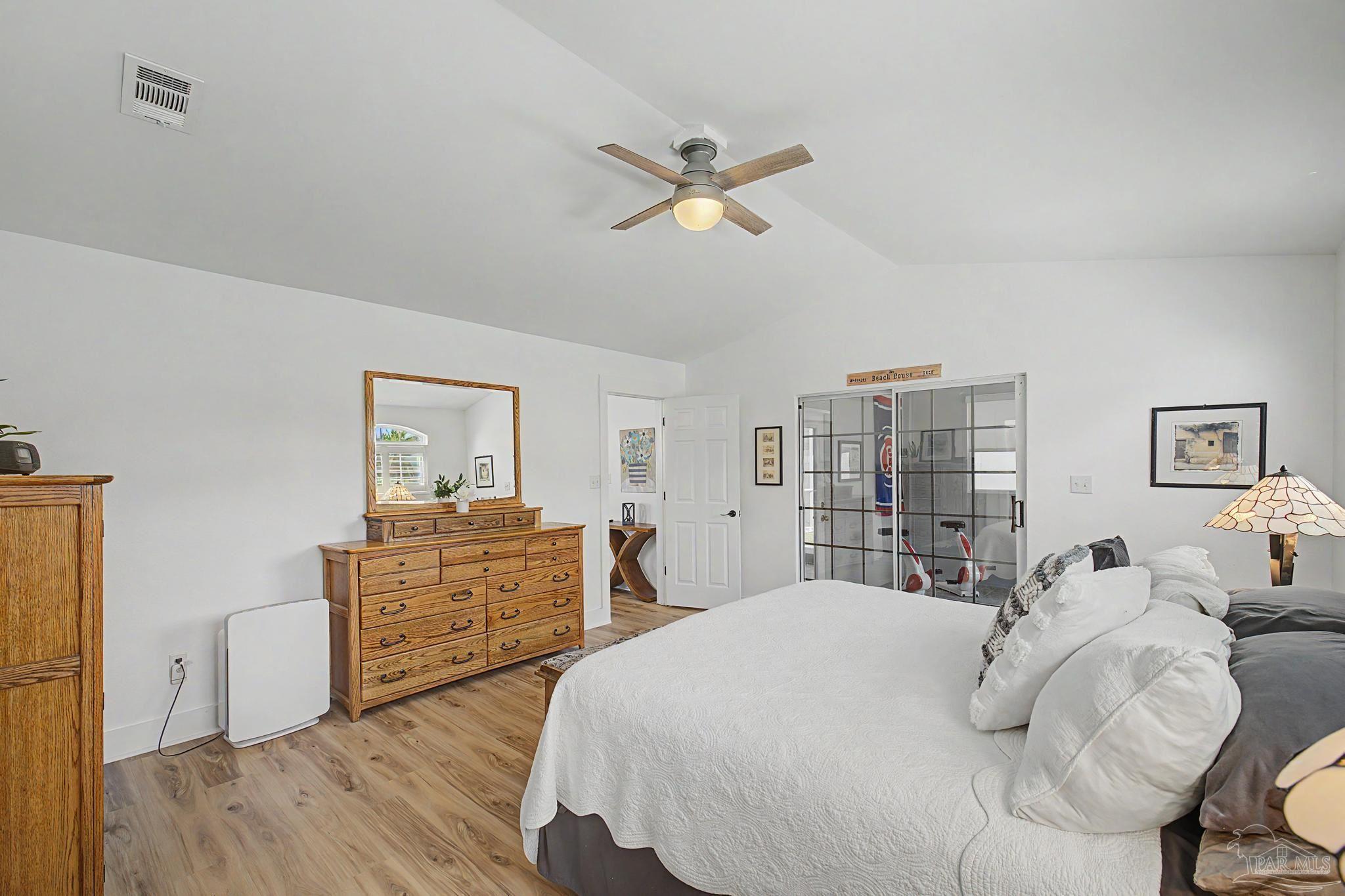 2005 Riviera Lane South Navarre, FL 32566 - Photo 19 of 70 a bedroom with a bed and wooden floor