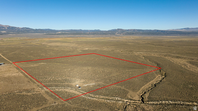 Aerial view of sparsely populated area featuring mountains and property boundaries highlighted