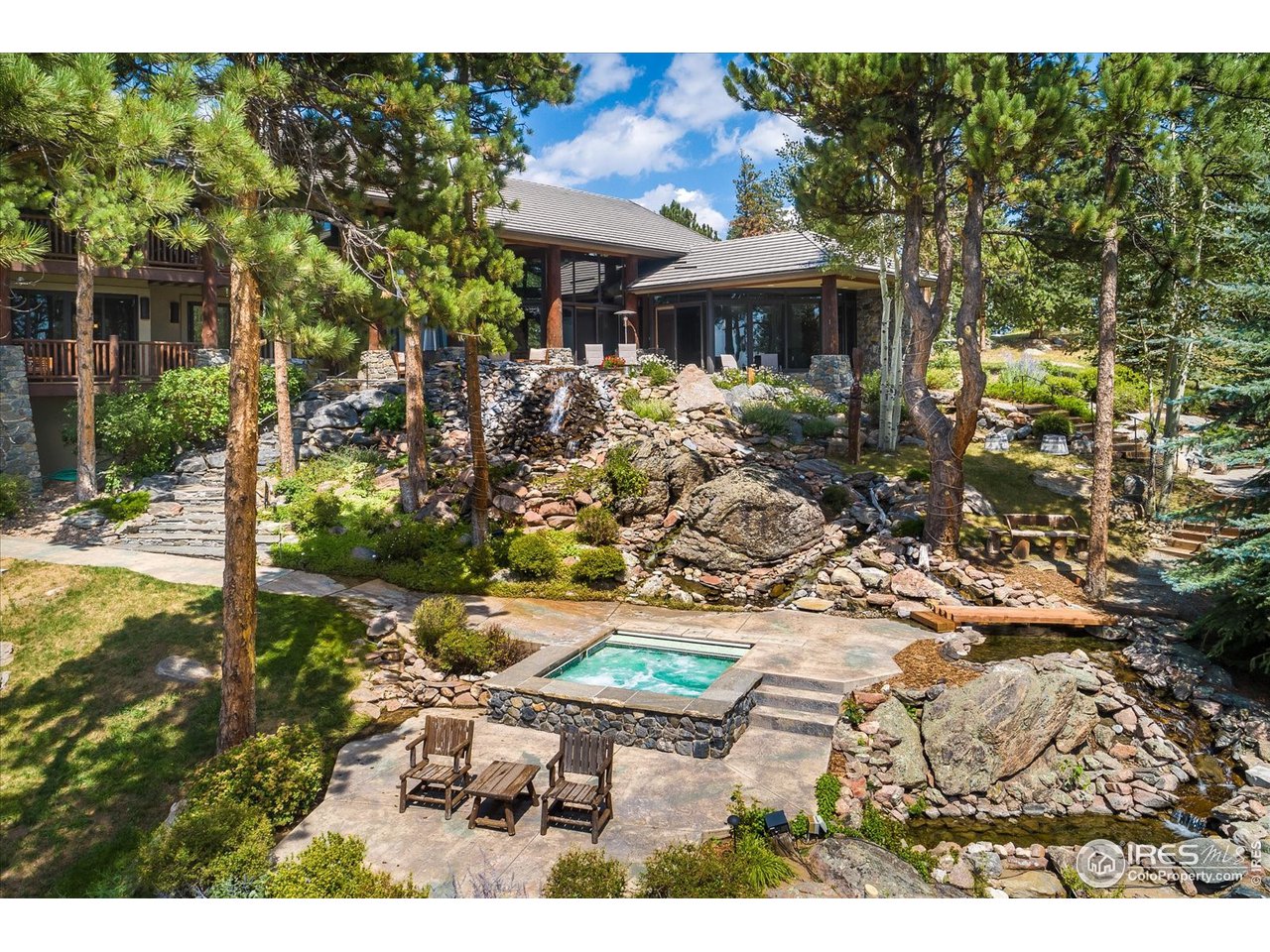 34750 Fox Ridge Road Evergreen, CO 80439 - Photo 21 of 39 Rear view with numerous intertwined water features and rock gardens.