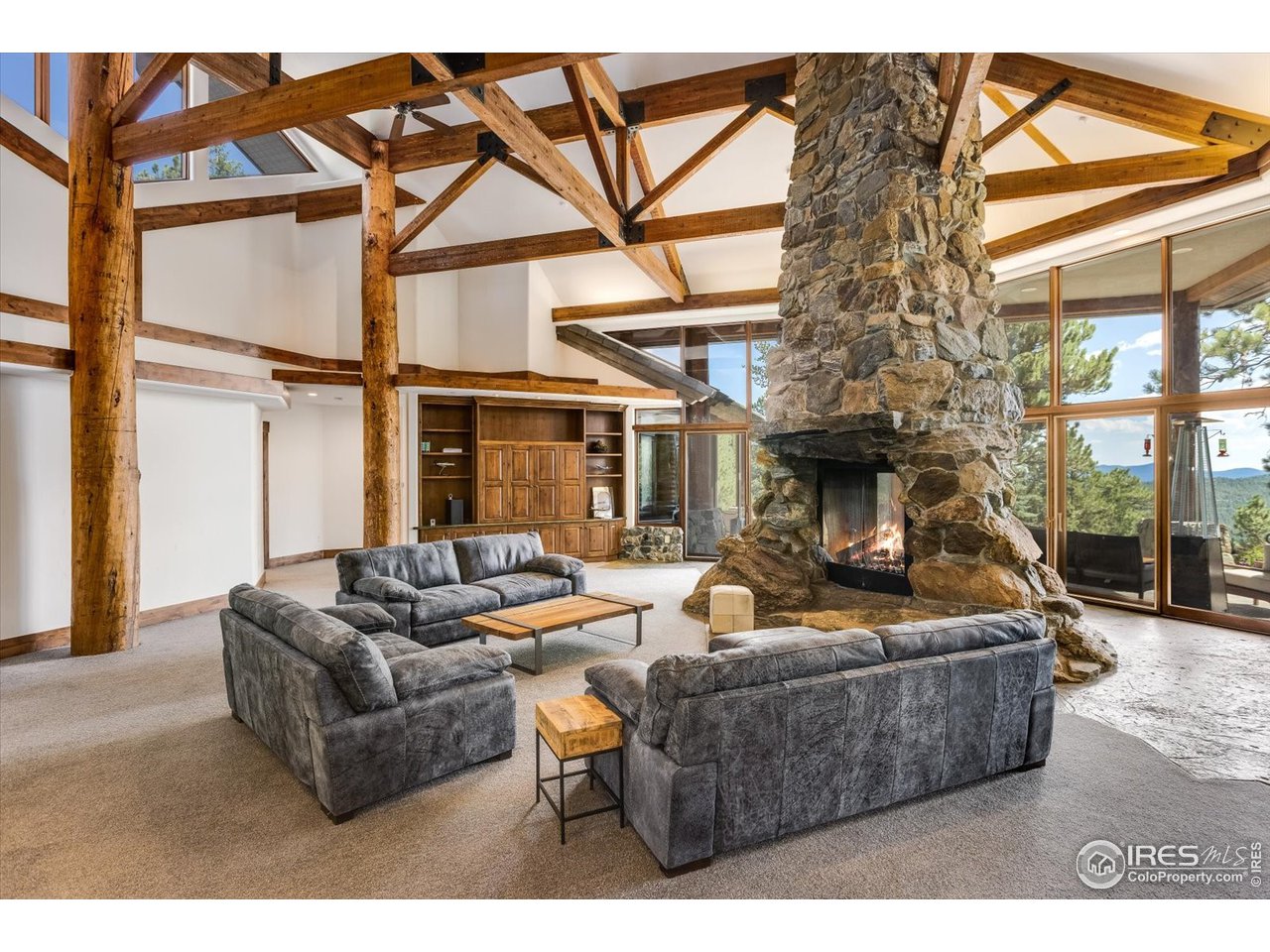 34750 Fox Ridge Road Evergreen, CO 80439 - Photo 33 of 39 Great Room with wood fireplace (with gas to create instant large fires).