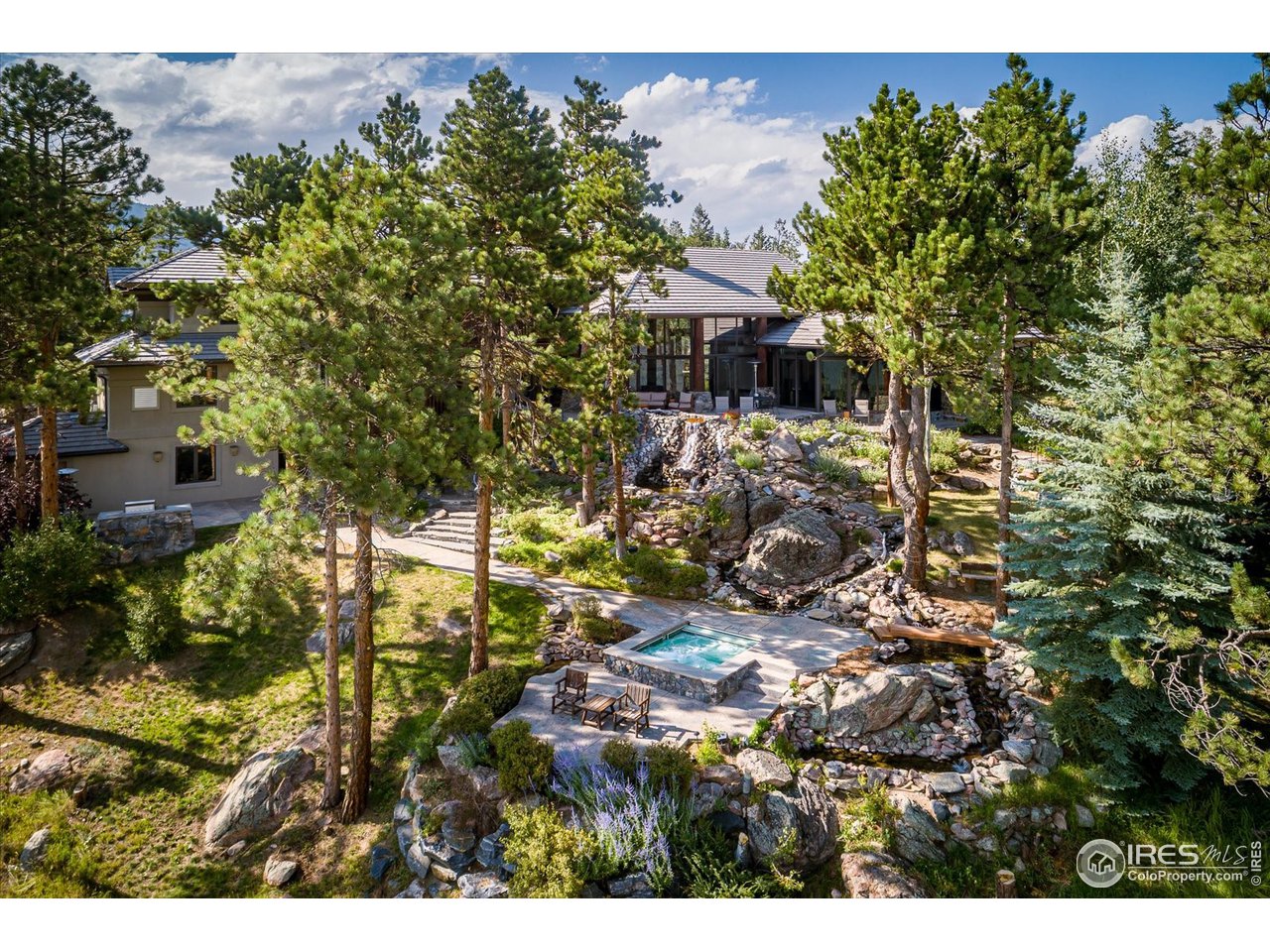 34750 Fox Ridge Road Evergreen, CO 80439 - Photo 5 of 39 Aerial photo looking at extensive water features and rock garden cascading down the property.