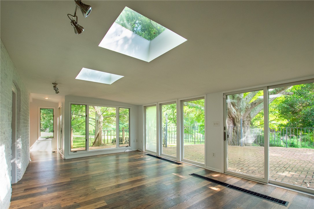 200 Chenault Road Townville, SC 29689 - Photo 21 of 47 Floor-to-ceiling glass and dual skylights illuminate this welcoming living space with a private patio beyond.