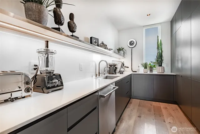 a kitchen with a sink a stove and cabinets