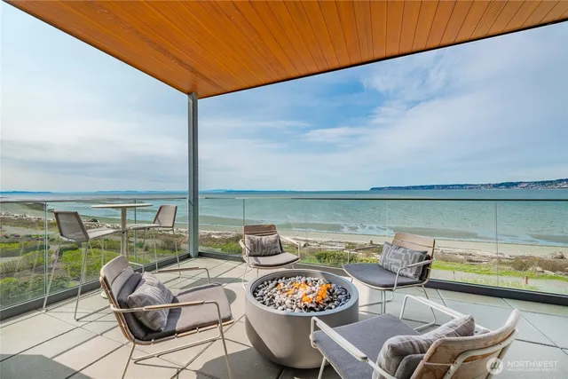 a view of a room with wooden floor and furniture
