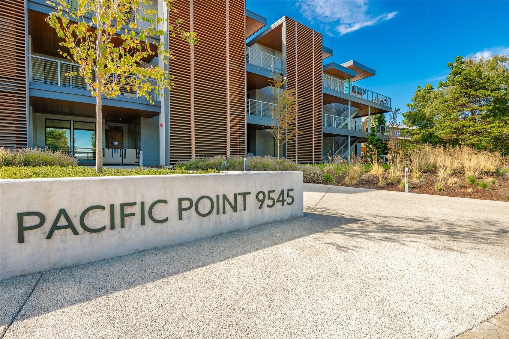 9545 Semiahmoo Parkway, Unit 201 Blaine, WA 98230 - Photo 3 of 40 a view of a brick building with a street sign