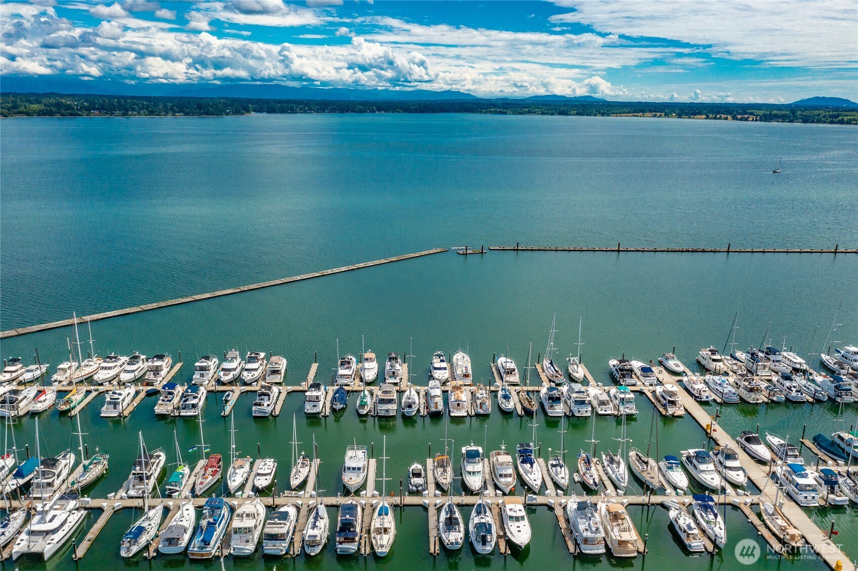 9545 Semiahmoo Parkway, Unit 201 Blaine, WA 98230 - Photo 37 of 40 a view of a lake with boats and trees in the background