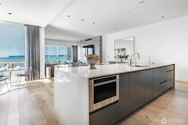 a kitchen with stainless steel appliances kitchen island a sink and a stove top oven