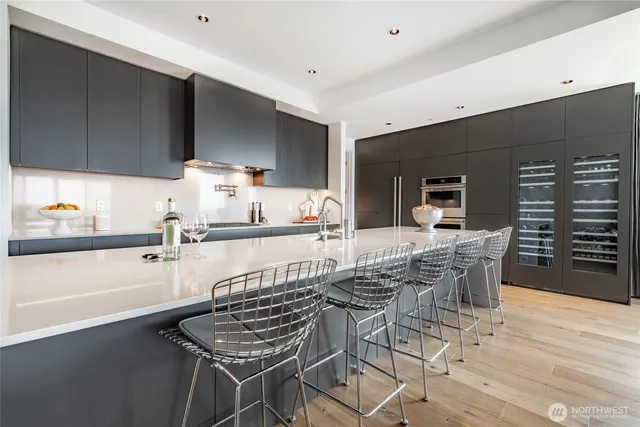 a kitchen with a kitchen island white cabinetry and appliances