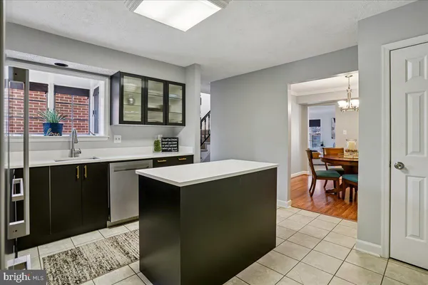 a kitchen with a sink and chairs