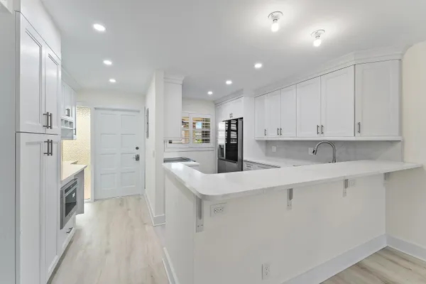 a kitchen with a refrigerator and a sink