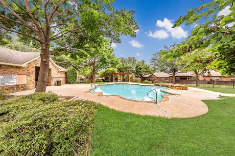 a view of a swimming pool with a yard
