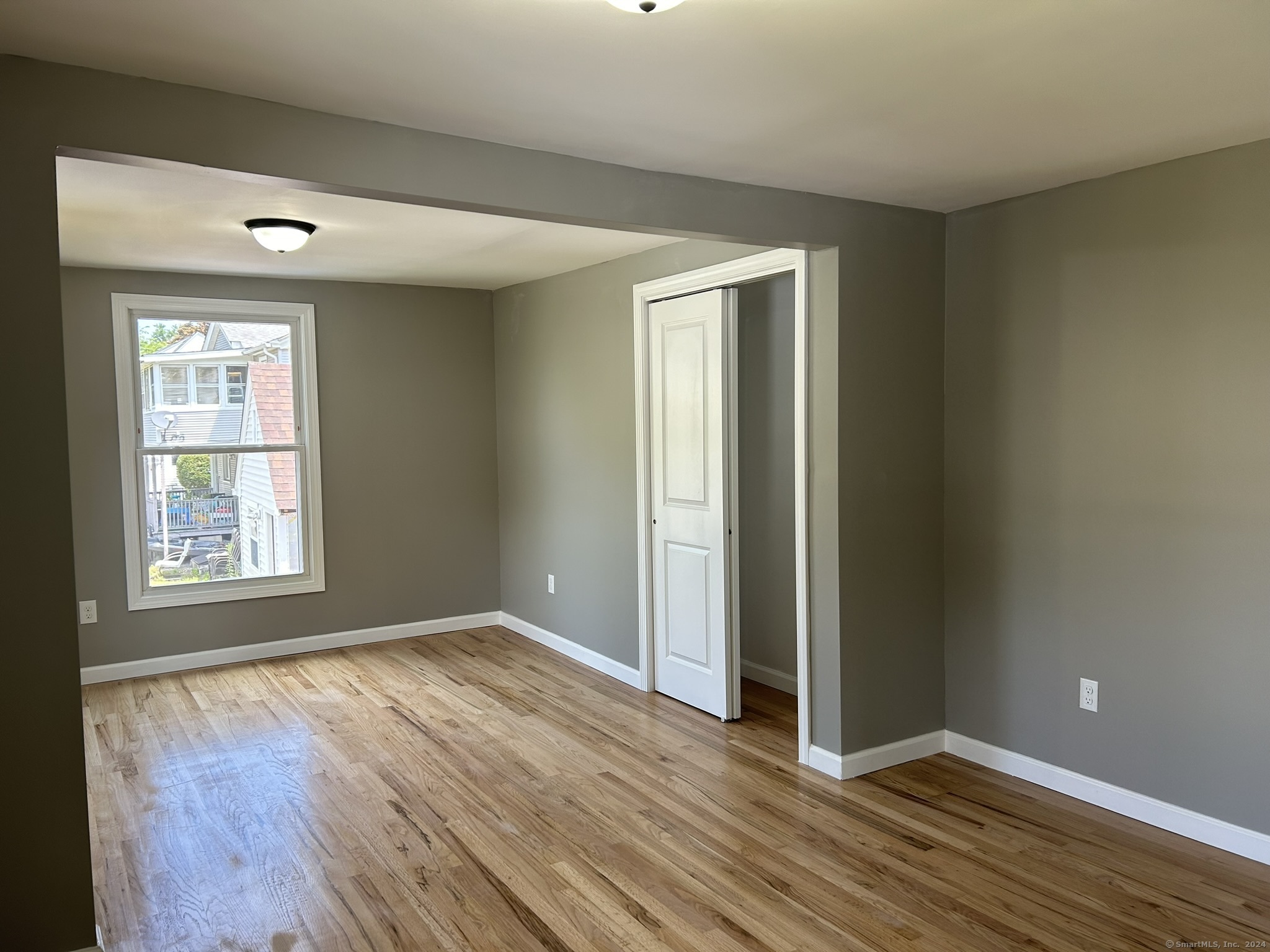 38 Beecher Street Southington, CT 06489 - Photo 7 of 12 an empty room with wooden floor and windows