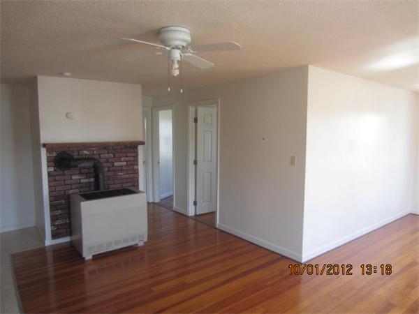 177 Nashua Street, Unit 5 Fall River, MA 02721 - Photo 5 of 15 a room with wooden floor and chandelier