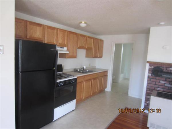 177 Nashua Street, Unit 5 Fall River, MA 02721 - Photo 7 of 15 a kitchen with stainless steel appliances granite countertop a refrigerator and a sink