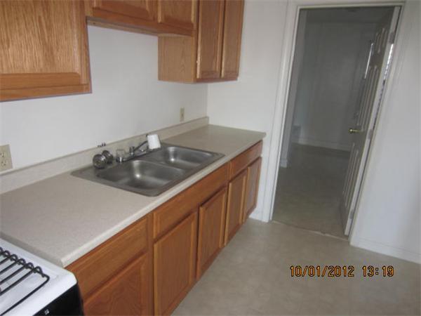 177 Nashua Street, Unit 5 Fall River, MA 02721 - Photo 8 of 15 a kitchen with sink cabinets and stove