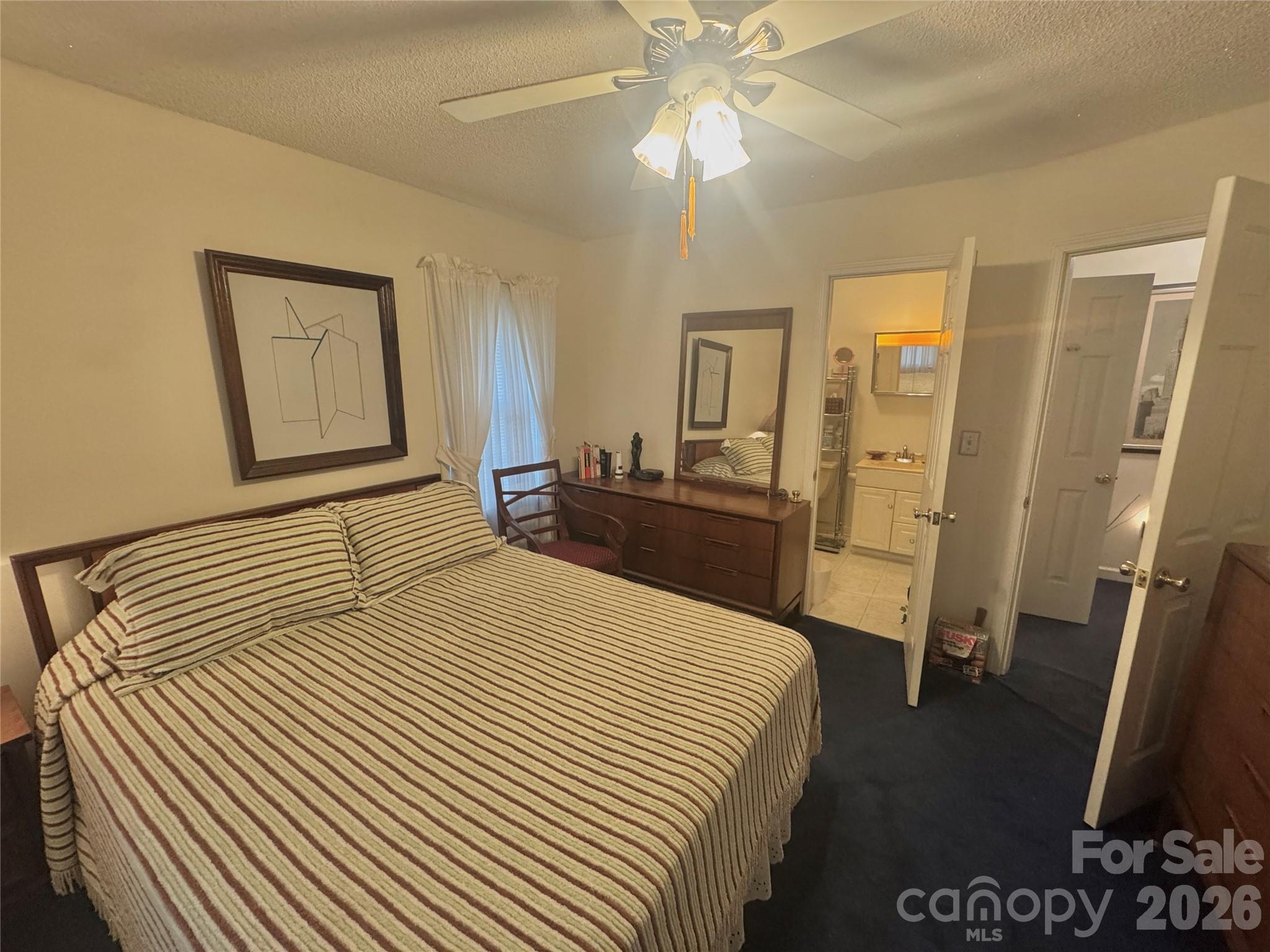 1529 West Market St Extension Cheraw, SC 29520 - Photo 24 of 38 a bedroom with a bed and a chandelier