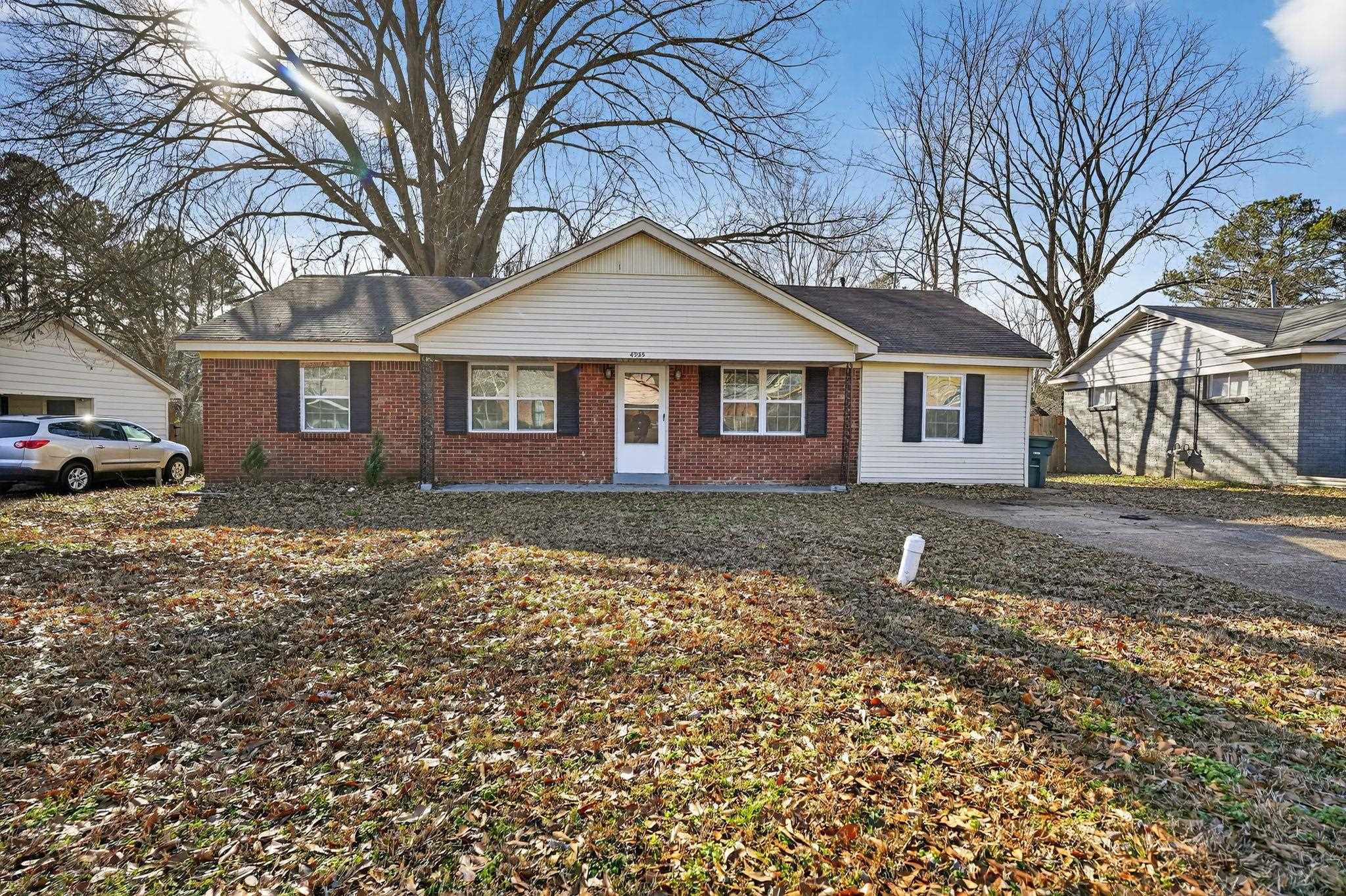 Ranch-style home with brick siding and covered porch