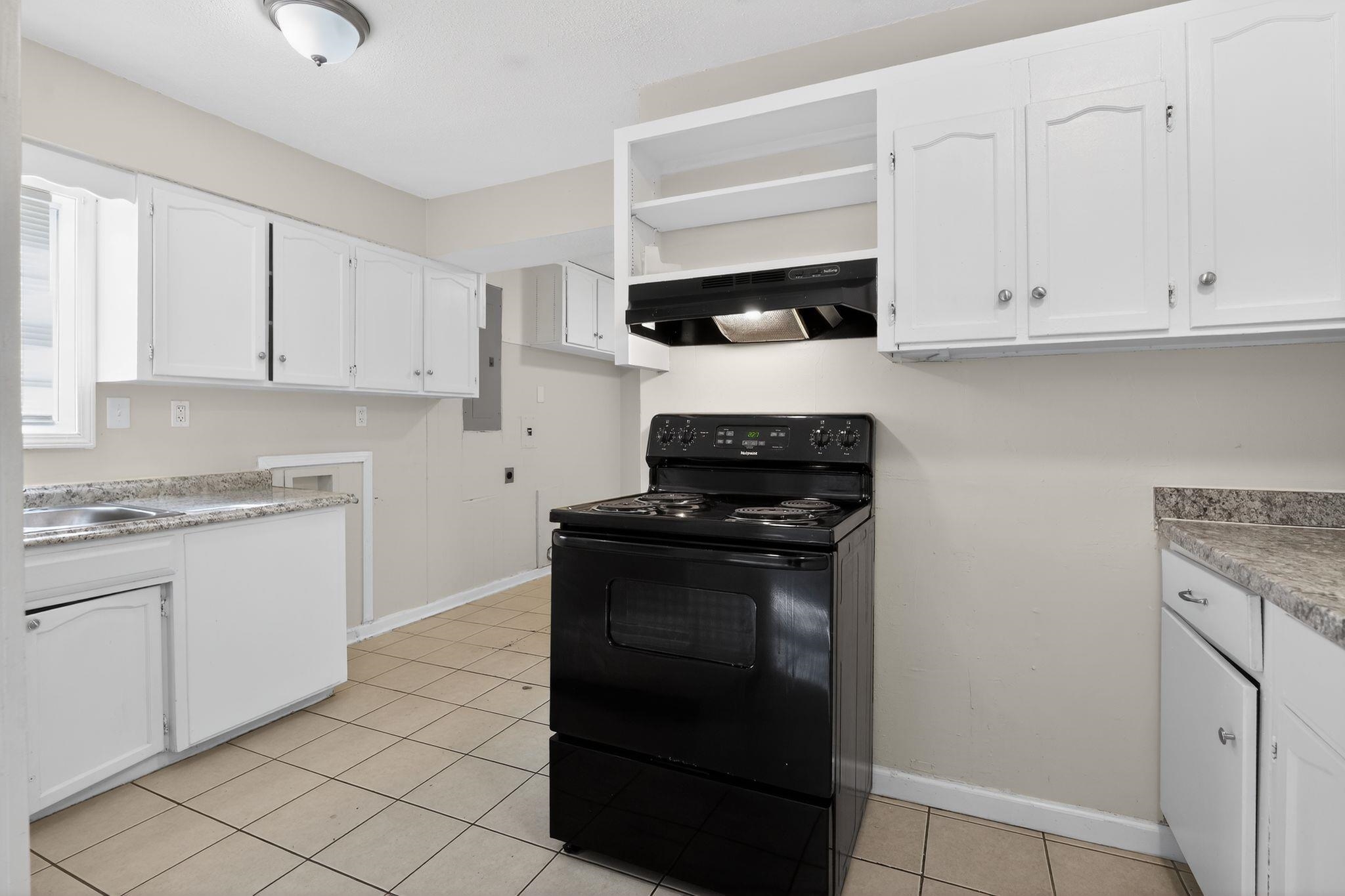 4285 Trudy Street Memphis, TN 38128 - Photo 13 of 31 Kitchen with black / electric stove, white cabinets, under cabinet range hood, and open shelves