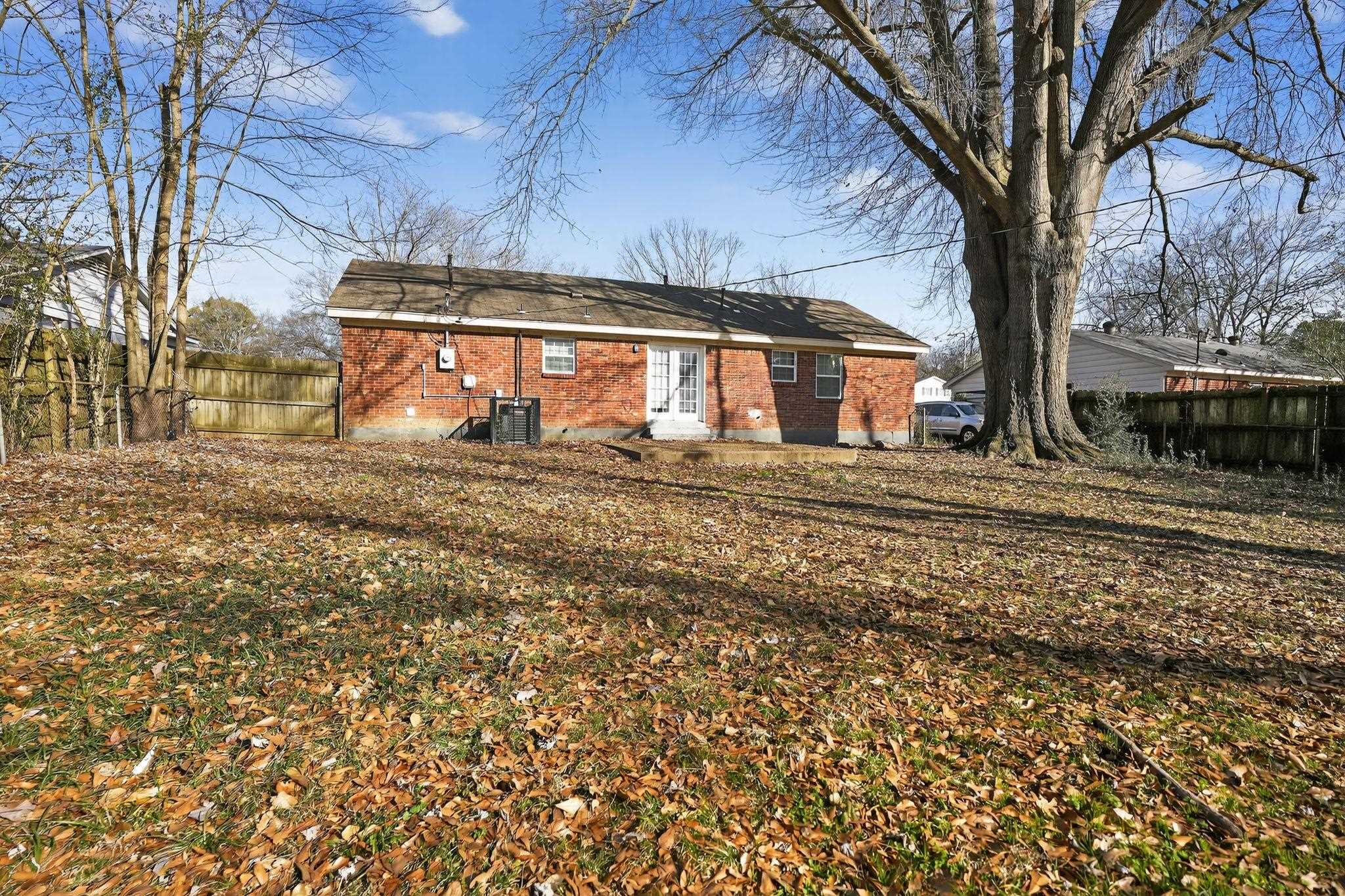 4285 Trudy Street Memphis, TN 38128 - Photo 28 of 31 Back of property with brick siding, a fenced backyard, and french doors