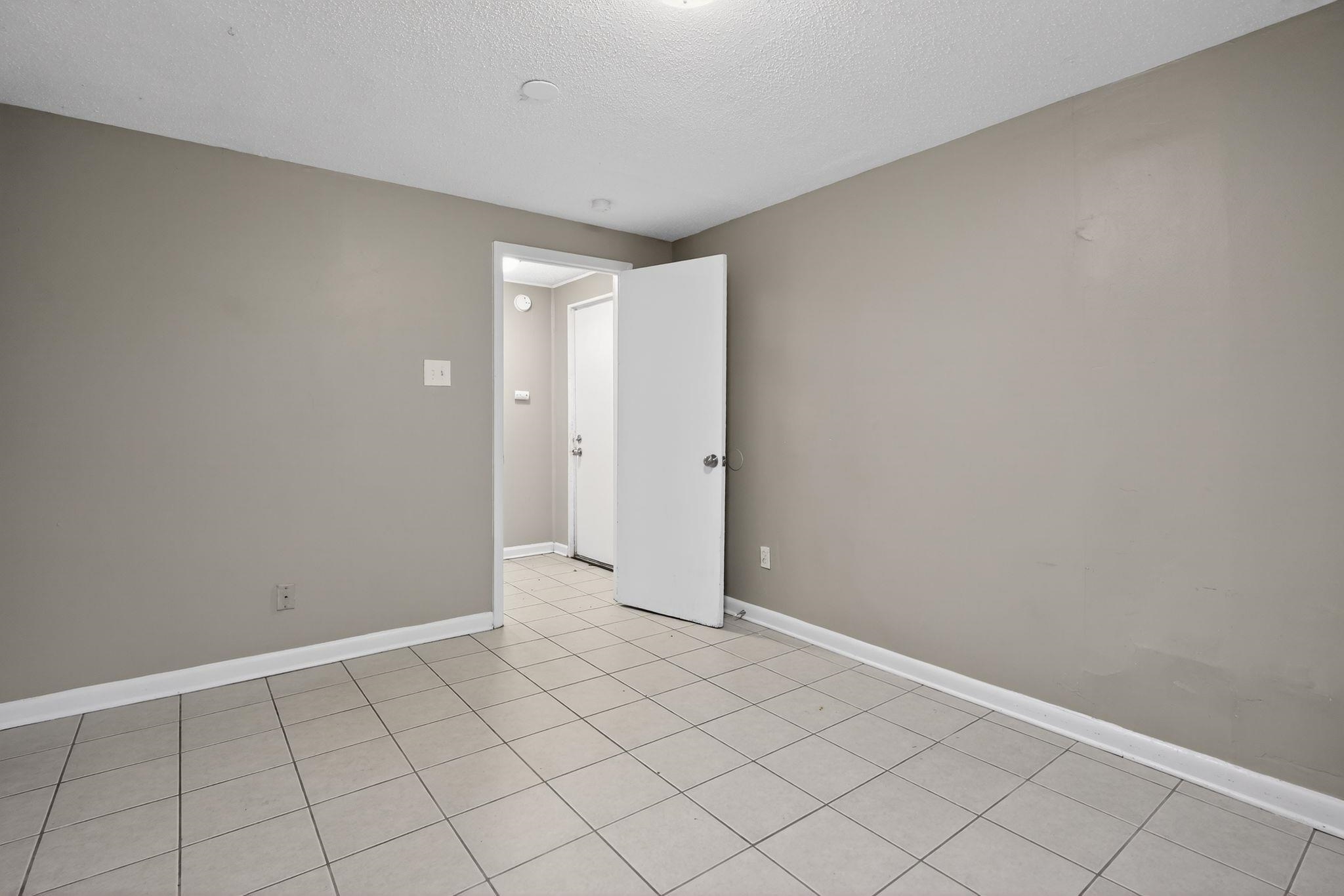 4285 Trudy Street Memphis, TN 38128 - Photo 9 of 31 Empty room featuring a textured ceiling and light tile patterned floors