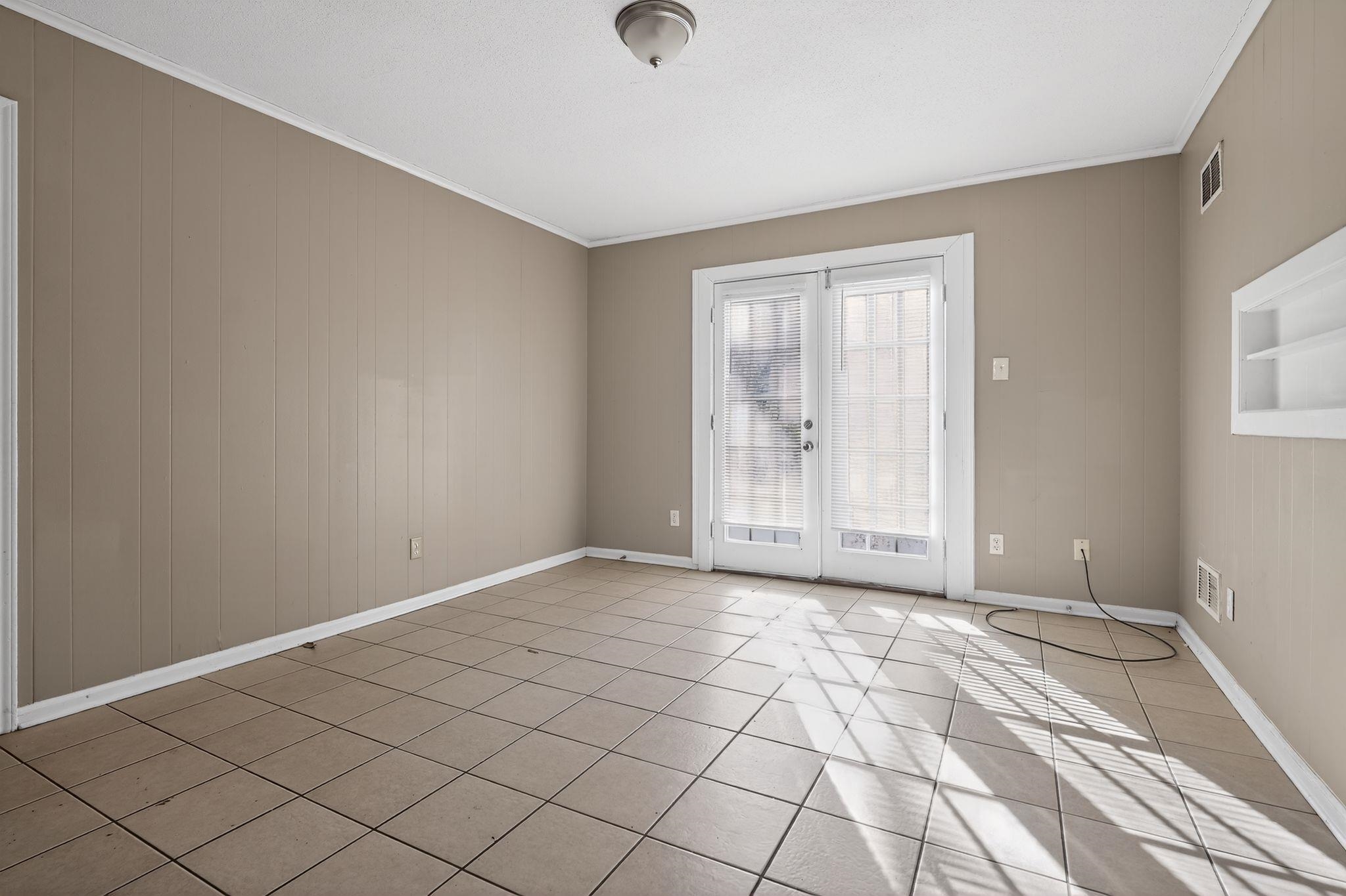 4285 Trudy Street Memphis, TN 38128 - Photo 10 of 31 Empty room with crown molding and light tile patterned flooring