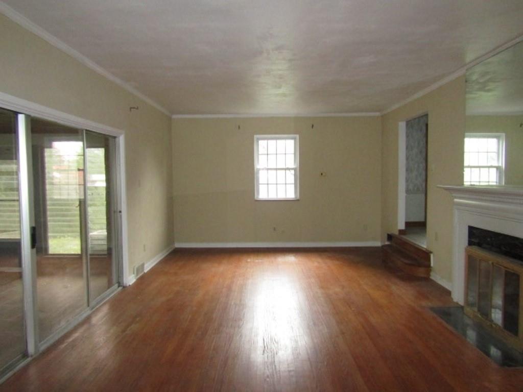 813 Coleman Drive Rochester, PA 15074 - Photo 20 of 33 an empty room with wooden floor fireplace and windows