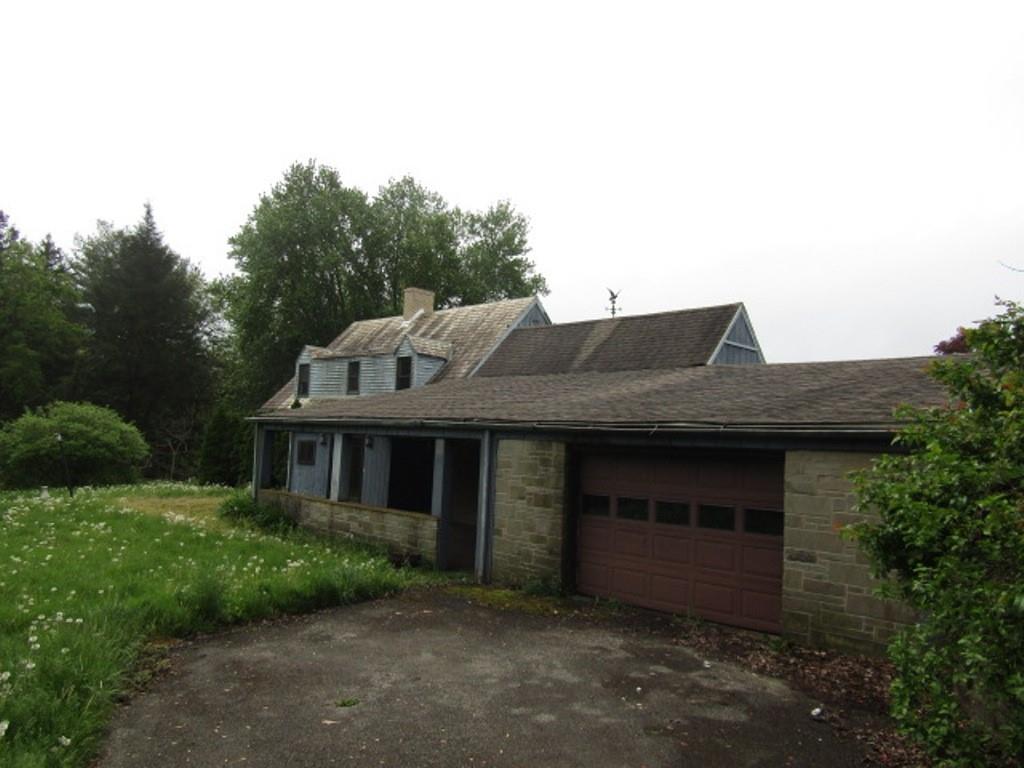 813 Coleman Drive Rochester, PA 15074 - Photo 6 of 33 a front view of a house with a garden