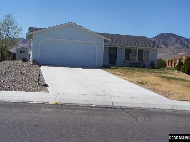 523 Yellow Jacket Road Dayton, NV 89403 - Photo 1 of 9 a front view of a house with a yard and garage
