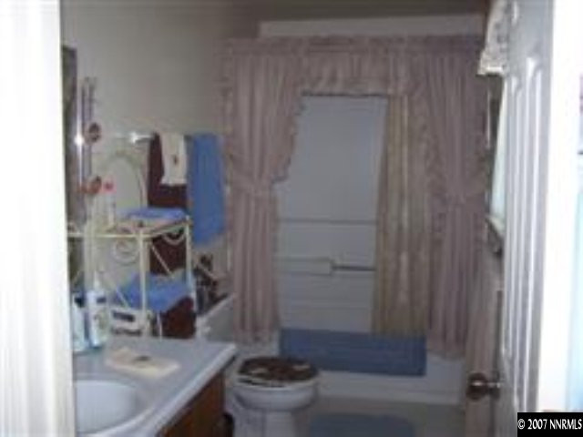 523 Yellow Jacket Road Dayton, NV 89403 - Photo 9 of 9 a bathroom with a granite countertop sink a toilet and shower