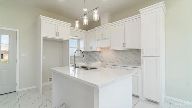 a kitchen with a sink a stove and cabinets