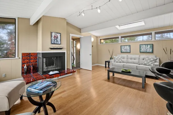 a living room with furniture and a floor to ceiling window