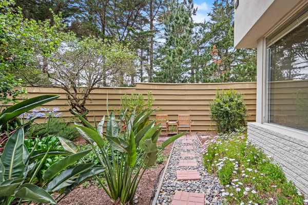a view of a patio with table and chairs and potted plants