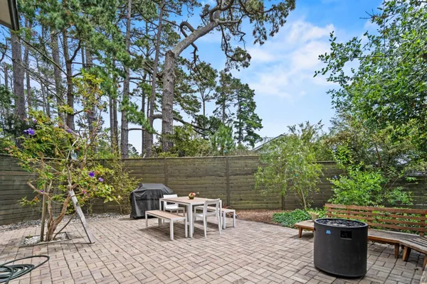 a view of a patio with table and chairs and potted plants