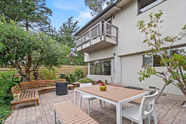 a view of a balcony with yard