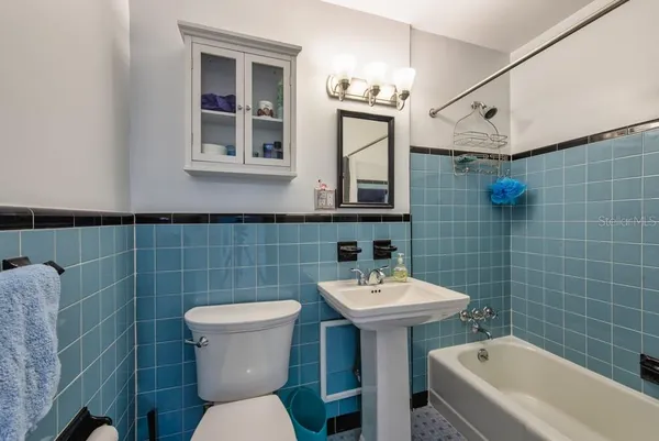 a bathroom with a sink a toilet and a bathtub