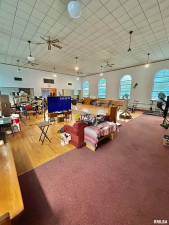 a view of a room with wooden floor and windows