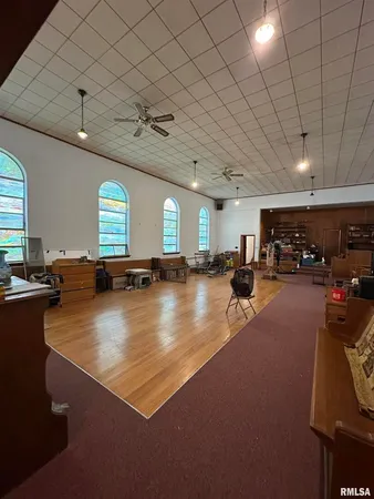 a large room with lots of furniture and a large window