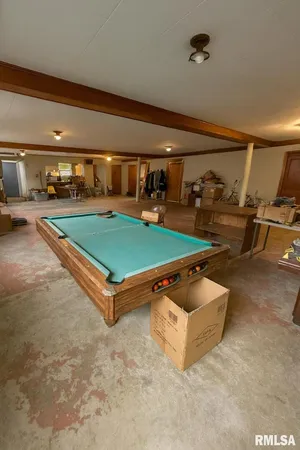 a living room with patio furniture and a table