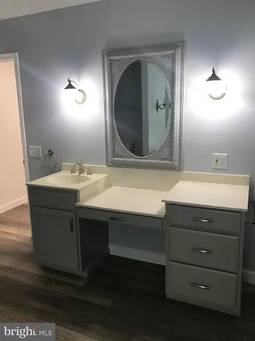 a spacious bathroom with a sink and a mirror