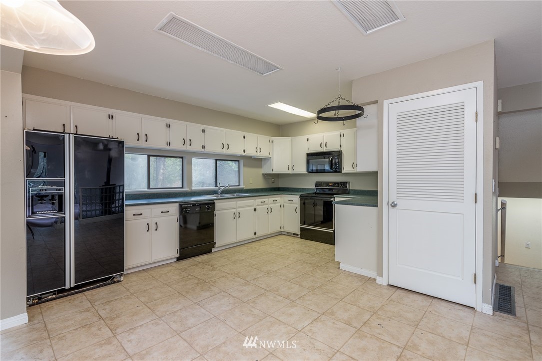2254 Cedar Point Avenue Point Roberts, WA 98281 - Photo 12 of 39 a kitchen with refrigerator and cabinets
