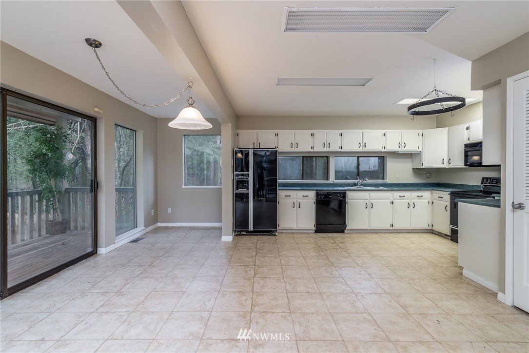 2254 Cedar Point Avenue Point Roberts, WA 98281 - Photo 13 of 39 a large kitchen with cabinets and stainless steel appliances