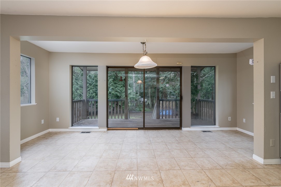 2254 Cedar Point Avenue Point Roberts, WA 98281 - Photo 14 of 39 a view of an empty room with glass door and windows