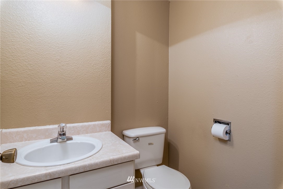 2254 Cedar Point Avenue Point Roberts, WA 98281 - Photo 19 of 39 a bathroom with a sink a toilet and a mirror