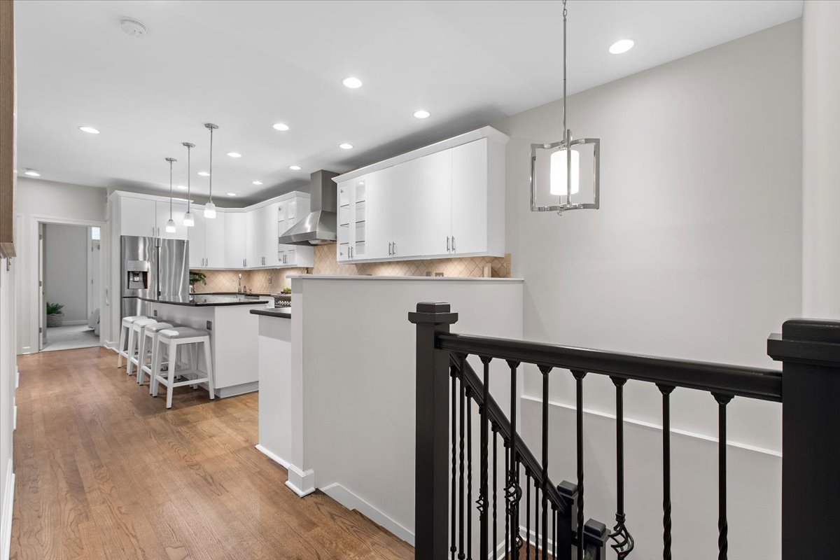 1867 North Halsted Street, Unit 1N Chicago, IL 60614 - Photo 11 of 30 a kitchen with kitchen island white cabinets and stainless steel appliances