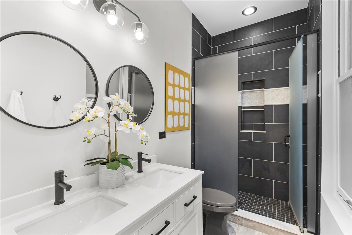 1867 North Halsted Street, Unit 1N Chicago, IL 60614 - Photo 17 of 30 a bathroom with a sink a toilet and a mirror